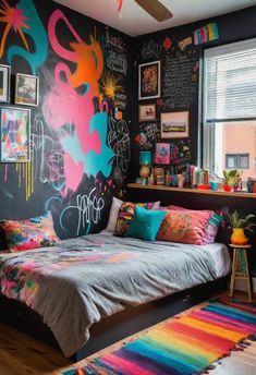 a colorful bedroom with black walls and lots of graffiti on the wall above the bed