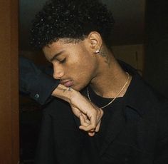 a young man wearing a black shirt looking at his cell phone