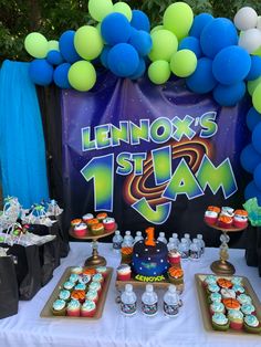 a table topped with lots of cupcakes and cakes