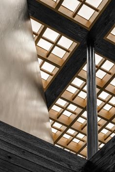 the inside of a building with wooden beams