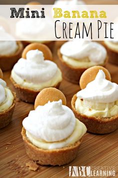 mini banana cream pies on a cutting board with whipped cream and graham crackers