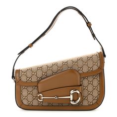 This is an authentic GUCCI Monogram Small Horsebit 1955 Asymmetric Shoulder Bag. This stylish shoulder bag is crafted of Gucci GG monogram fabric. The bag features a front flap with a silver horse-bit detail, and adjustable leather handle. The bag opens to a beige fabric interior with a zipper pocket. Silver Horse, Gg Monogram, Gucci Monogram, Horse Bits, Stylish Shoulder Bag, Beige Fabric, Beige Brown, Leather Handle, Brown Sugar