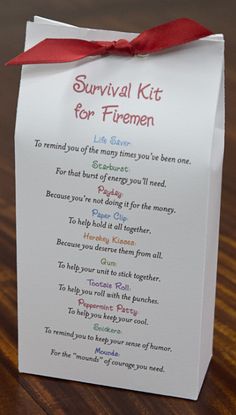 a survival kit for firemen on a wooden table with a red ribbon around it