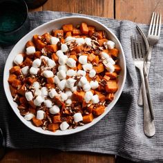 a bowl filled with marshmallows on top of a table