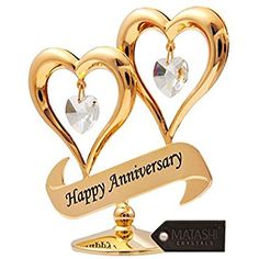 two gold hearts are on top of each other, with the words happy anniversary written in black