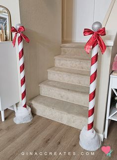 two red and white candy canes are on the stairs