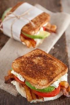 two sandwiches sitting on top of white paper