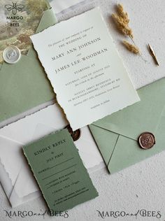 the wedding stationery is laid out on top of each other, including an envelope