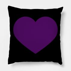 a black and purple pillow with a heart on it's front side, against a white background