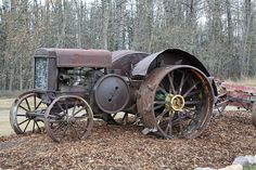 an old steam engine sitting in the grass