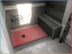 the inside of a cement box with red flooring