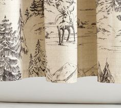 a curtain with an image of a moose in the woods on it's side