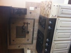 a black stove top oven sitting inside of a kitchen next to cabinets and counter tops