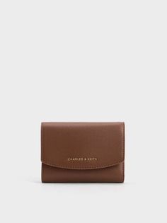 Chocolate Curved Front Flap Wallet | CHARLES & KEITH Versatile Brown Wallet With Rfid Blocking, Versatile Brown Wallets With Interior Card Slots, Versatile Brown Wallet With Card Slots, Versatile Brown Wallet For Daily Use, Brown Compact Trifold Wallet, Compact Brown Trifold Wallet For Everyday, Compact Brown Wallet With Interior Card Slots, Elegant Brown Trifold Wallet For Everyday, Modern Brown Trifold Wallet