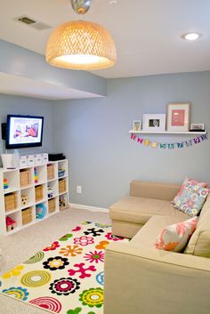 a living room filled with furniture and a flat screen tv on top of a wall