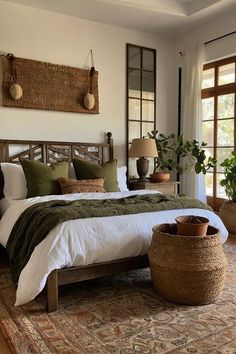 a bedroom with a large bed and two plants on the side of the bed in front of it