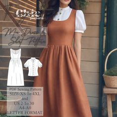 a woman standing in front of a window wearing an orange dress and white collared shirt