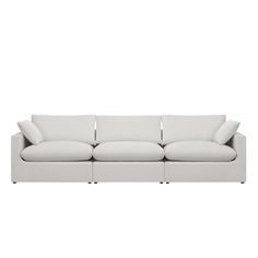 a white couch with four pillows on it's back and one arm facing the camera