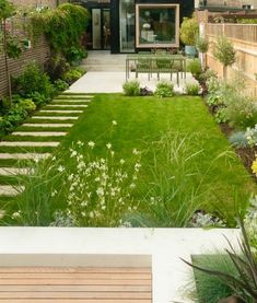 an outdoor garden with grass and flowers