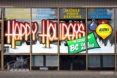 a store front with large windows covered in graffiti and advertisements on the side of it