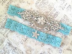 "Beach Wedding Garter, No Slip Starfish Garters, Starfish Bridal Garter, Rhinestone and Pearls, Starfish Wedding - 1801-T -Gorgeous rhinestone garter set wedding garter set. Keepsake features rhinestone and pearl beading and a pearl starfish. The toss includes a Pearl starfish button; both on your choice of lace (shown in 1\" turquoise lace) - Note- we carry matching flower girl baskets, ring pillows, sashes, and headpieces  ------CUSTOMIZE YOUR GARTER----- Please leave COLOR SELECTIONS and NEED Rhinestone Garter, Starfish Wedding, Blue Starfish, Aqua Beach, Aqua Wedding, Turquoise Lace, Pearl Beading, Ring Pillows, Pearl Beach