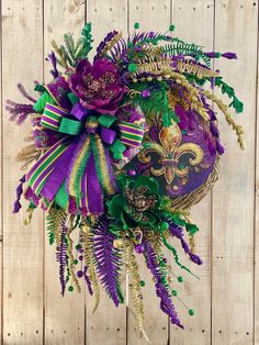 a mardi gras wreath with purple and green decorations