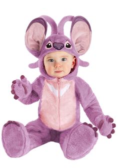 a baby dressed in a purple mouse costume