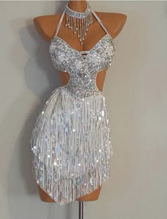 a mannequin wearing a silver dress with sequins on it