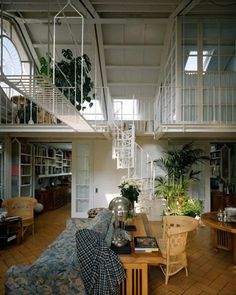 a living room filled with lots of furniture and plants on top of it's shelves