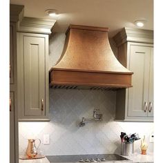 a stove top oven sitting inside of a kitchen next to white counter tops and cabinets