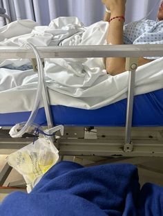 a person laying in a hospital bed with an oxygen tube