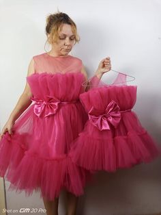 Hot Pink Mommy and Me Party Dress Set 🎉: Share amazing moments with your little ones! Perfect for birthdays 🎂, special occasions 🌟, and Mom and daughter photoshoots 📸. 💖 Barbie-inspired dresses with matching bowtie hairbands 🎀. 👶 Satin diaper covers for kids up to 3 years old 🍼. 👗 Buy for just Mom or just Daughter . 📏 Available in US numeric sizes - ask for custom colors and sizes! 🌈 🧼 Keep dresses fresh: Wash in 30-degree max 🌊. Get ready for unforgettable moments with your mini-me Summer Party Princess Fairy Dress, Princess Style Fairy Dress For Summer Party, Princess Style Summer Fairy Dress For Party, Princess Fairy Dress With Ruffles For Party, Princess Style Party Dress With Bow, Fitted Tutu Dress With Bow For Party, Pink Sleeveless Tutu Dress For Party Season, Cute Ruffle Fairy Dress For Party, Cute Sleeveless Fairy Dress For Party