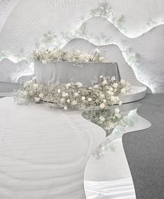 a white wedding setup with flowers on the table