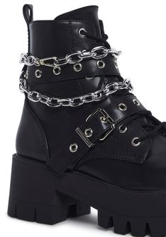 These boots have a vegan leather construction, treaded soles, buckle details, a removable silver chain link, front lace-ups, and side zipper closures. Edgy Boots With Chain And Round Toe, Edgy Chain Boots With Round Toe, Edgy Chain Boots For Streetwear, Edgy Boots With Chain Strap And Round Toe, Chain Detailed Round Toe Boots For Streetwear, Chain Detail Boots With Round Toe For Streetwear, Chain Detail Round Toe Boots For Streetwear, Chain-decorated Round Toe Boots For Streetwear, Trendy Chain Boots For Fall