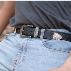 Crafted from 9-10oz USA steer hide, this belt is slow embossed and hand-tooled with a beautiful classic western pattern. The belt is finished with a traditional western buckle and matching silver toned hardware. One solid piece of leather. No bonded belts, period. This results in a belt that minimizes stretch and will never break or crack at the holes. The tough full grain leather is taken from the hide and handcrafted into a belt that you'll pass down to your kids. FEATURES: 1.6'' (40 mm) wide Cognac Belt, Western Pattern, Western Buckles, Work Project, Rfid Blocking Wallet, Western Design, Black Leather Belt, Brown Belt, Leather Work