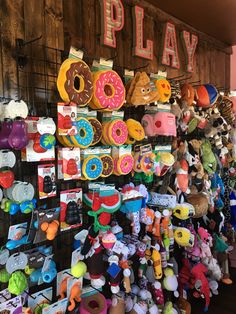 there are many stuffed animals and toys for sale at the playroom wall display area