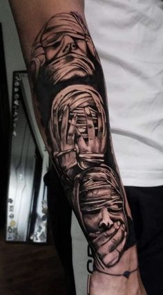 a man with a tattoo on his arm that is covered in black and grey ink