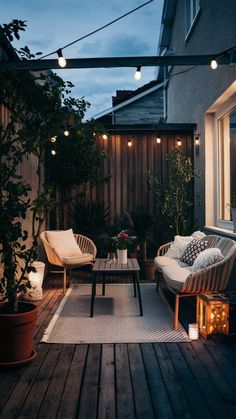 an outdoor patio with lights and furniture on the deck at night, lit up by string lights