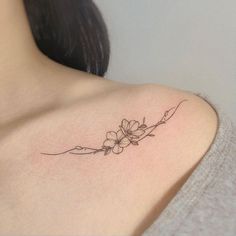 a woman with a flower tattoo on her shoulder