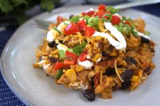 a close up of a plate of food with rice, beans and vegetables on it