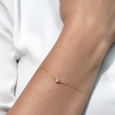 Embrace modern luxury with this 14 Karat Gold Bracelet, featuring a mesmerizing solitary cubic zirconia--a stylish accessory that complements any look. Specifications: * Made with premium 14 Karat Solid Gold for lasting beauty and durability. * Center Measurements: 5 mm * Chain Style: Classic cable chain, * The total length, including the extension, is 7 inches. * Chain Thickness: 0.5 mm * Clasp: Spring Ring Clasp  * Style: Minimalist  Crafted exclusively from genuine solid gold, our jewelry gua Luxury Single Diamond Tennis Bracelet For Formal Occasions, Modern Diamond Bracelet With Brilliant Cut For Gift, Modern Gold Bracelet With Brilliant Cut As Gift, Modern Diamond Bracelet With Brilliant Cut As A Gift, Modern Round Cut Tennis Bracelet As Gift, Fine Jewelry Cubic Zirconia Tennis Bracelet With Single Diamond, Modern Diamond Bracelet With Single Diamond For Wedding, Modern Brilliant Cut Gold Bracelet As Gift, Modern Wedding Diamond Bracelet With Single Diamond