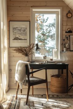 a desk with a chair and pictures on the wall in front of it, next to a window