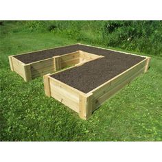 two wooden raised garden beds in the grass