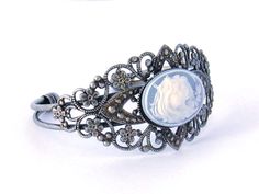 "Two Sisters Cameo Bracelet/Victorian Cameo Bracelet/Cameo/Victorian Cameo Jewelry/Sisters Cameo/Silver Cameo Cuff Bracelet/Wedding Jewelry Victorian Cameo Cuff Bracelet featuring two sisters 25 x 18 mm cameo on a black background set in an antiqued pewter filigree cuff bracelet. Also available in blue. Beautifully detailed antiqued pewter finished brass cuff adjusts to comfortably fit a wrist between 5.75 and 7.75 inches. This is a popular gift for sisters and best friends. Brides - Please conv Victorian Antique Silver Bracelets For Wedding, Antique Silver Cuff Bracelet For Wedding, Luxury Cameo Bracelets For Formal Occasions, Vintage Antique Silver Cuff Bracelet For Wedding, Antique Adjustable Cuff Bracelet For Wedding, Antique Cameo Bracelet For Wedding, Elegant Cameo Wedding Bracelets, Elegant Silver Bracelet With Cameo, Ornate Antique Silver Cuff Bracelet For Weddings