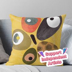 a pillow with an image of a face on it and the words support independent artists