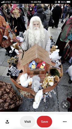 a man with long white hair and beard holding a boat filled with stuffed animals