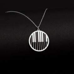 "Piano Keys Necklace in Sterling Silver is made by hand in our workshop with care. All our jewelry is the most elegant choice for the Bridesmaids, friends, your loved ones and for yourself. Piano Keys Necklace in Sterling Silver * Material: High Quality Solid 925 Sterling Silver. * Dimensions: Depending on your font choice, height sizes range from 1,5 mm to 3,5 mm lowercase. * Finish: Sterling Silver ∙ Gold ∙ Rose Gold. HOW TO ORDER ❓ * Select your necklace COLOR. * Choose necklace length from 1 Silver Music-themed Necklace For Gift, Nickel-free Sterling Silver Music-themed Necklace, Music-themed Sterling Silver Pendant Necklace, Sterling Silver Music-themed Pendant Necklace, Music-themed Pendant Necklaces As Gift, Silver Music-themed Round Jewelry, Music-themed Pendant Necklace As Gift, Music-themed Pendant Necklace, Nickel-free Music-themed Jewelry As Gift