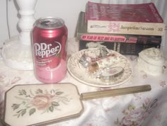 a table topped with plates and cups filled with cake next to a can of dr pepper