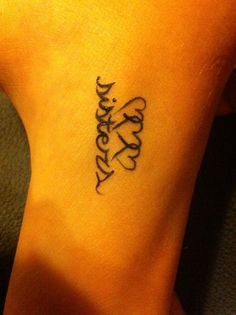 a woman's foot with a tattoo that says happy on the bottom and an inscription in cursive writing