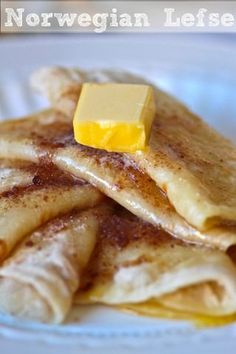 pancakes with butter and syrup are on a white plate that says norwegian leftover crepes